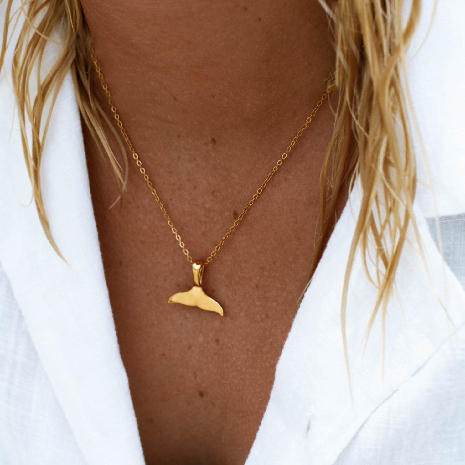 whale-tail-necklace-on-model-white-shirt